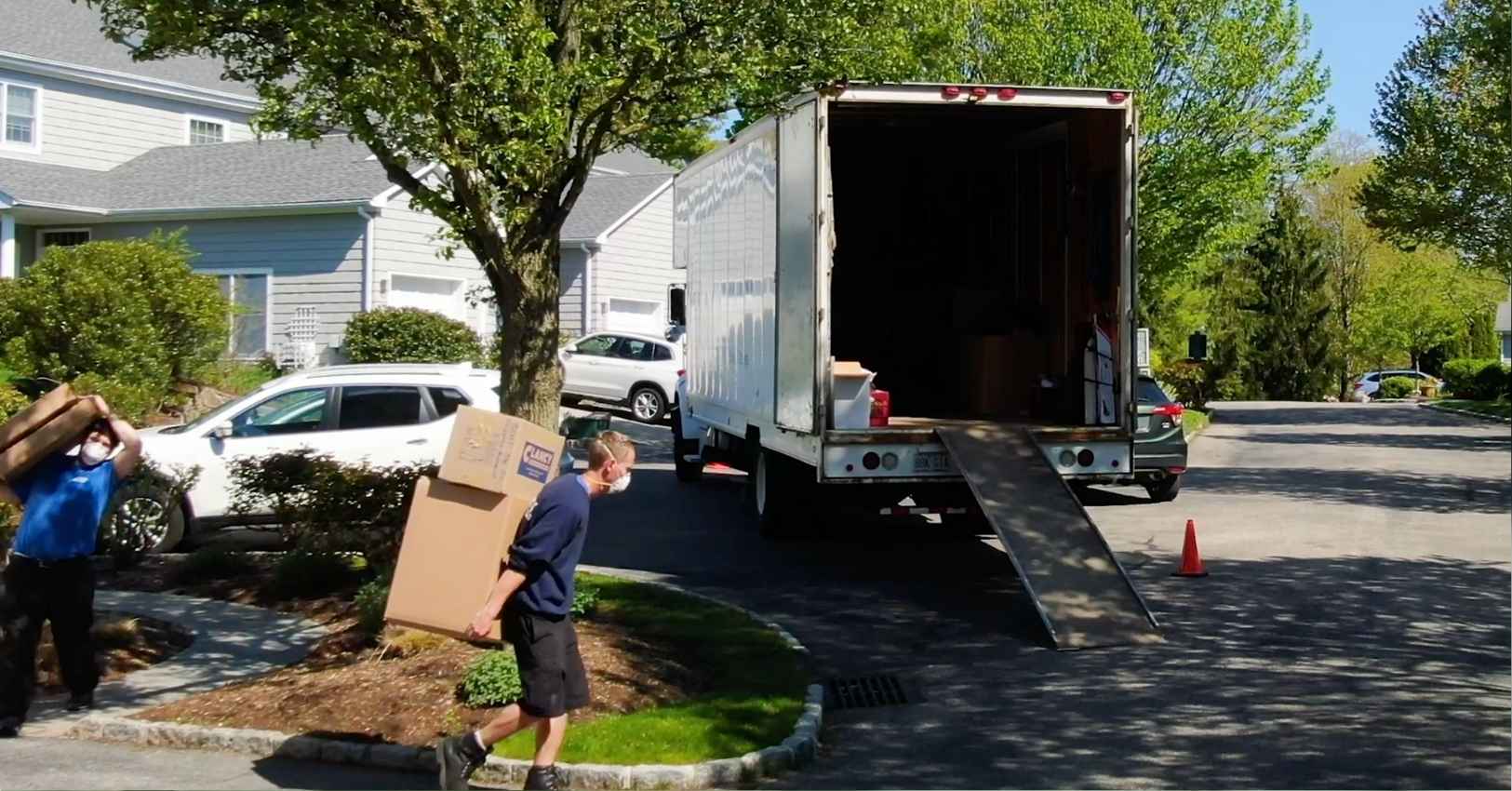 License mover carrying a package on his back to their truck