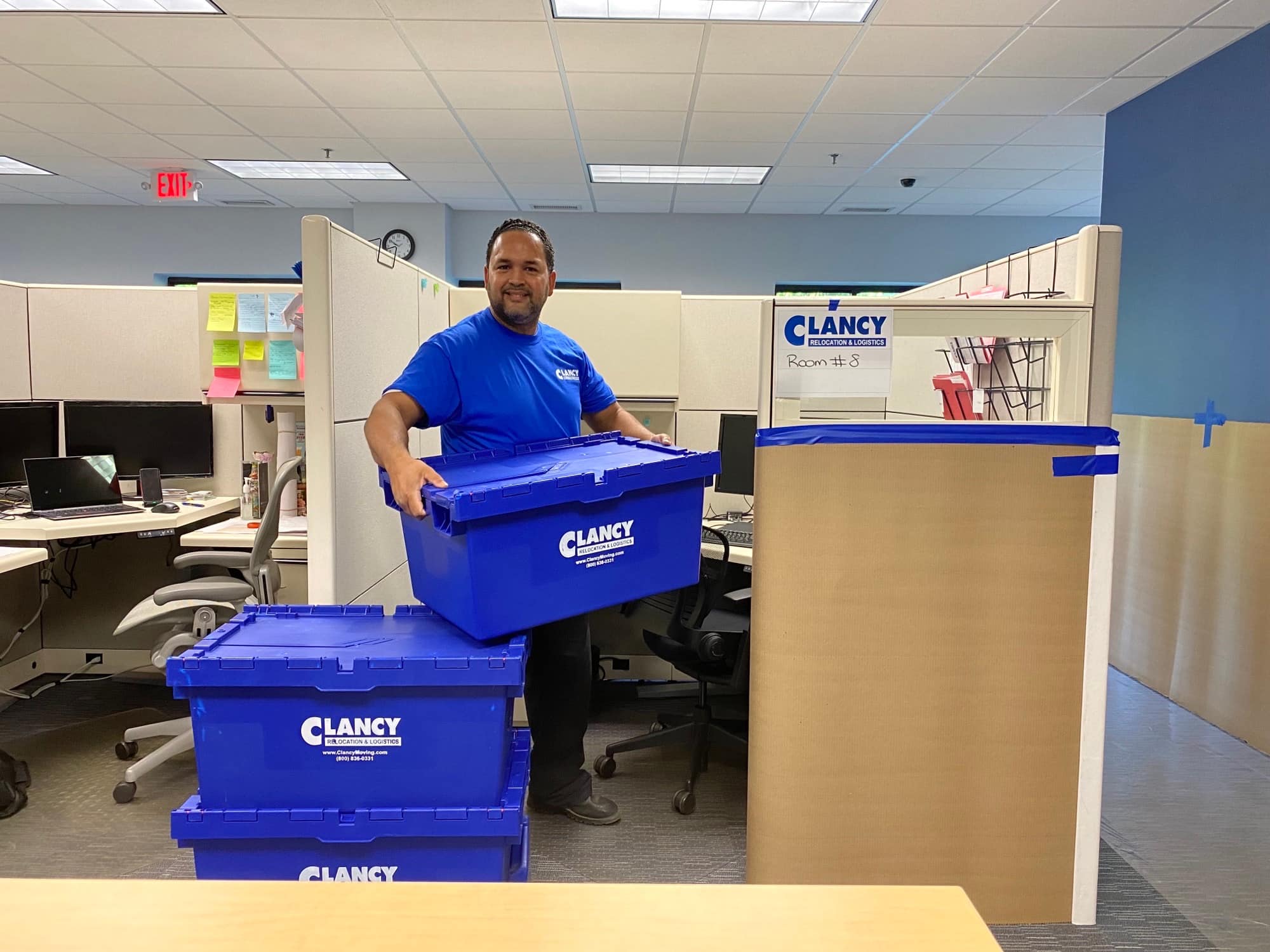 men carrying storage boxes