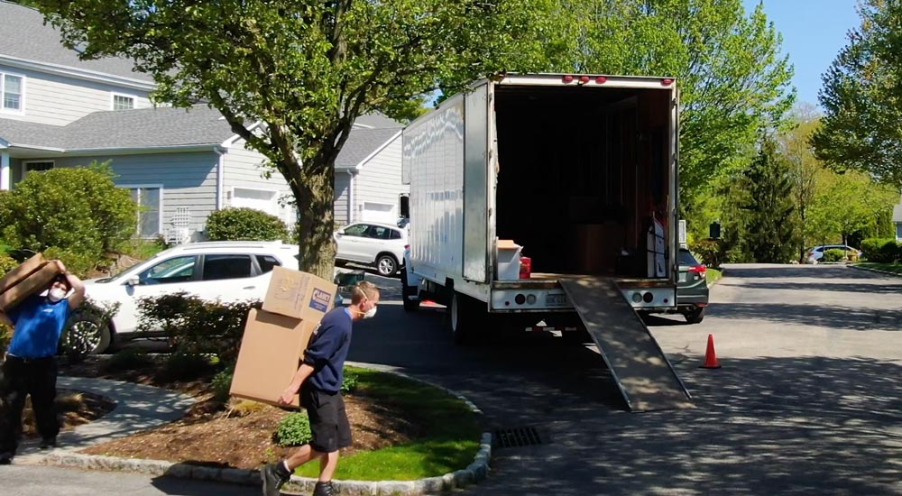 mover carrying packages on his back